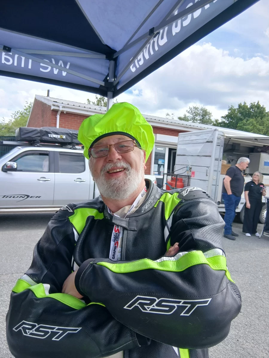 Smiling rider wearing a high visibility helmet cover